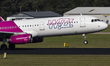 The departing Wizz Air Airbus A321 aircraft as seen taxiing, take off, roation and flying...