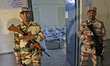 Security personnel are standing guard outside a strong room, where EVMs are kept, while th...