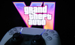 GTA VI logo from the trailer displayed on a laptop screen and PlayStation DualSense contro...