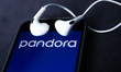 Headphones and Pandora logo displayed on a phone screen are seen in this illustration phot...