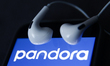 Headphones and Pandora logo displayed on a phone screen are seen in this illustration phot...