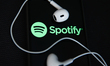 Headphones and Spotify logo displayed on a phone screen are seen in this illustration phot...