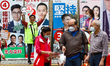 Workers for a pro-Beijing group are urging citizens to vote on the polling day of the city...