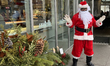 A man dressed as Santa Claus is greeting children outside a mall in Toronto, Ontario, Cana...
