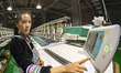 A worker is making embroidery orders at a workshop of a textile enterprise in Congjiang Co...