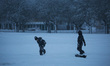 Children are playing with snow during a snowfall in Linköping, Sweden, on December 22, 202...