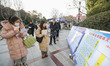 Candidates for the master's degree entrance examination are lining up to enter the test ce...