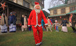 A man dressed as Santa Claus is participating in the Christmas celebrations at the Holy Fa...