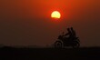 A man is riding his bike as he returns home during sunset in Nagaon District, Assam, India...