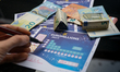 A man is checking a box to pick numbers on a betting card for the EuroMillions jackpot in...