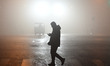 A citizen is walking on a foggy road in Fuyang, China, on December 30, 2023. 