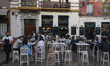 People are enjoying the atmosphere on the terrace of Casa Lola, a typical tavern for tasti...