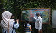 A guide is accompanying tourists as they visit the Japanese tunnel, also known as Lobang J...