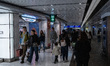 People are walking past shops at Hong Kong International Airport in Hong Kong, China, on J...