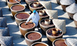 A worker at a soy sauce factory is checking the drying of sauces in a drying field in Lian...