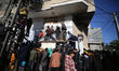 Palestinians are queuing to buy bread from a bakery in Deir al Balah, central Gaza Strip,...