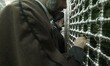 Two clerics are praying next to the tomb of Fatima Masumeh, the sister of Imam Reza, in th...