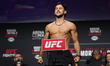 Claudio Puelles of Peru is posing on the scale during the UFC Fight Night ceremonial weigh...