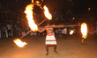 Tamil Hindu devotees are performing a votive dance while twirling fire as they celebrate t...