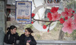 Two Iranian schoolgirls are sitting together without wearing mandatory headscarves under t...