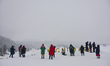 People are clicking pictures during a blizzard at the Ski resort in Gulmarg, Baramulla dis...