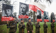 Students wearing uniforms hold banners while attending an official ceremony during the Nat...