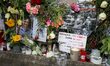 This photograph, taken in Paris, France, on March 4, 2024, shows flowers and candles being...