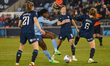Khadija Shaw, wearing number 21 for Manchester City, is taking a shot at goal during the F...