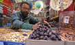 A shop owner is sorting a variety of dates before 'iftar' on the first day of Ramadan in S...
