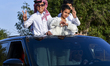 Children are peering out of the top of their car sunroof in Doha, Qatar, on March 14, 2024...