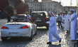 Qatari men are watching the car parade. During Ramadan, before sunset, Katara Cultural Vil...