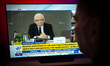 A woman is seen wathcing the televised testimony of Jaroslaw Kaczynski at the Pegazus inqu...