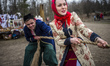People dressed in traditional costumes celebrate Maslenitsa in Ukrainian rites in Mamayeva...