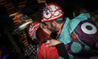 Participants are kissing during the nighttime carnival parade in Patra, Greece, on March 1...