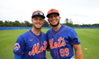 Drake Osborn #13 and Ronald Hernandez #99, minor league catchers for the New York Mets, ar...