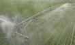 A farmer is using a water-saving pivot sprinkler for spring irrigation in Zouping, China,...