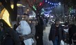 Iranian people are standing in line to receive Iftar meals in downtown Tehran during the h...