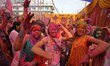 People are playing with colors during Holi celebrations in Nagaon district, Assam, India,...