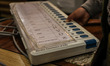 Government officials are using an Electronic Voting Machine (also known as EVM) during a t...