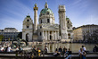 People are enjoying the sunny spring weather in front of the Karlskirche (St. Charles Chur...