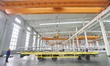 Workers are operating a solar laminating machine production line at the ''Photovoltaic Int...