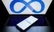 The Meta logo is being displayed on a smartphone screen and on a computer screen in Athens...