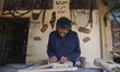 Mohamed Ghaly, a 57-year-old simsimiya maker, is crafting the traditional instrument in Po...