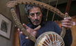 Mohamed Ghaly, a 57-year-old simsimiya maker, is crafting the traditional instrument in Po...