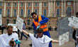 A protester is pouring false bitumen on activists in Toulouse, France, on May 4, 2024. Ext...
