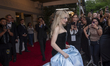 Sabrina Carpenter is wearing Thom Browne as she departs the Pierre Hotel for the 2024 Met...