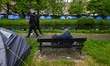DUBLIN, IRELAND - MAY 8:An asylum seeker seats on a public bench along the peaceful banks...