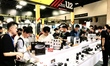 Visitors are looking at photographic equipment at the 25th China International Photographi...