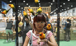 Visitors are feeding pet parrots inside a large cage at the Pet Expo Thailand 2024 at Quee...