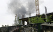 A pillar of smoke is rising over the city after the shelling of Russian troops in Kharkiv,...